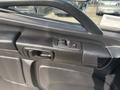 Close-up of the door handle and window controls of a 2012 Hino 338 truck