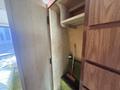 Interior of a 1976 GMC Motorhome featuring a closet space with a broom and shelving against wooden paneling