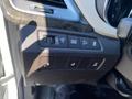 Close-up of the control panel in a 2018 Hyundai Santa Fe featuring buttons for drive mode, parking assist, and traction control