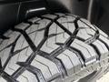 Close-up of a rugged tire with deep treads designed for off-road performance on a 2018 RAM 1500
