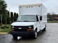 A white 2008 Chevrolet Express box truck with a smooth front, black grille, and large cargo area in the back