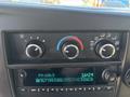 Dashboard controls of a 2020 Chevrolet Express showing climate control knobs and a radio display