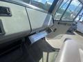 The interior view of a 1997 Freightliner FL70 showing the dashboard with controls and a fold-down step for easy access to the cabin