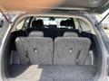 Interior view of the rear cargo space of a 2022 Kia Sorento with the back seats folded down and a spacious carpeted area