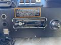 Dashboard of a 2009 Morgan Olson Workhorse W62 featuring control buttons a car stereo and a warning sign about vehicle operation