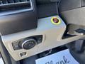 A dashboard control panel of a 2019 Ford F-150 featuring various knobs and switches along with a yellow power button