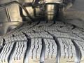 Close-up of a rugged tire tread from a 2016 Ford Transit 150 showing deep grooves and detailed surface patterns designed for traction and performance