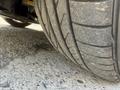 Close-up of a worn tire from a 2004 BMW 6-Series showing tread patterns and weathering details