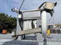 A metal frame with a wheel and straps attached designed for securing loads likely part of an International 7300 Workstar truck setup