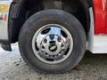 Close-up of a chrome wheel from a 2013 Chevrolet Silverado 3500HD featuring the Chevrolet logo in the center and a rugged tire tread design
