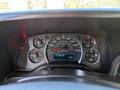 Dashboard of a 2017 Chevrolet Express displaying speedometer fuel gauge and odometer showing 215366 km with various warning lights on the panel