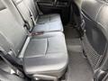 Interior view of the back seat area of a 2021 Toyota 4Runner with black leather upholstery and a carpeted floor mat