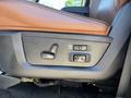 Detail of the seat adjustment controls for a 2015 RAM 1500 featuring buttons for reclining and height adjustment in a leather interior
