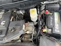 Close-up view of the engine compartment of a 2011 Dodge Ram 5500 showing various components like the battery coolant reservoir and engine parts