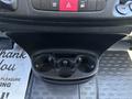 The image shows the interior console of a 2016 RAM Promaster featuring a cup holder with three compartments and control buttons on the dashboard above