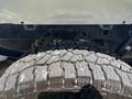 Close-up of a rugged tire with deep treads specifically designed for off-road use attached to a 2021 Ford F-150 truck