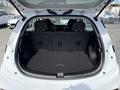 The trunk of a 2023 Chevrolet Bolt EV with a spacious black carpeted area and folded rear seats