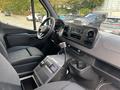 Interior view of a 2020 Mercedes-Benz Sprinter 2500 featuring front seats a dashboard with controls and a center console with storage compartments and a gear shifter