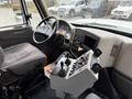 Interior view of a 2012 International 7400 with a driver's seat dashboard control panel and steering wheel visible