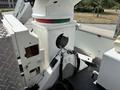 White and red machinery section of a 2012 International 7300 Workstar featuring a circular opening with hoses and wires connected