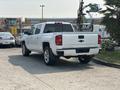 A white 2017 Chevrolet Silverado 1500 parked with a prominent rear view showcasing its sleek design and chrome accents