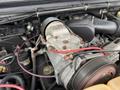 Engine components of a 2000 Ford F-450 with visible alternator and wiring showcasing mechanical details