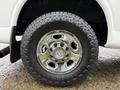 Close-up of a chrome wheel and rugged tire from a 2021 Chevrolet Express vehicle