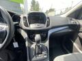 Interior view of a 2015 Ford Escape featuring a dashboard with a digital display gear shift and various control knobs