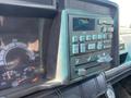 Close-up of the dashboard of a 1996 GMC Top Kick featuring various controls gauges and a digital display