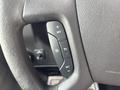 Close-up of the steering wheel of a 2018 Chevrolet Express showing the cruise control buttons including set resume and an on/off switch
