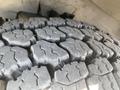 Close-up of the tire tread on a 2011 Chevrolet Express showing deep grooves and patterns for traction