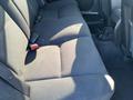 The interior of a 2006 Pontiac G6 showing the back seat with fabric upholstery and seat belts visible