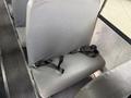 A gray bus seat with a black safety belt attached to it