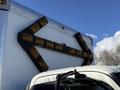 A 2014 Hino 195 box truck with yellow directional LED lights mounted on the back in an arrow formation