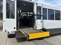A 2020 Chevrolet Express with an extended wheelchair ramp positioned in the doorway for accessibility