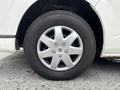 A silver alloy wheel of a 2009 Toyota Hiace with a black tire featuring the name "Firestone" on the sidewall