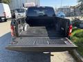 A 2018 Ford F-150 with an open truck bed featuring a textured bed liner and no cargo inside