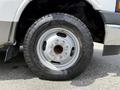 A close-up of a 2017 Chevrolet Express tire featuring a silver wheel rim with multiple bolts and a rugged tire tread pattern