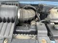 Close-up view of a 2006 Ford Econoline engine with visible air intake system hoses and components
