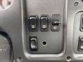 Close-up of the control panel of a 2013 Freightliner 114SD showing switches for locked functions and an engine brake