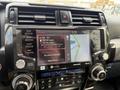 The interior dashboard of a 2021 Toyota 4Runner featuring a touchscreen display with radio options and navigation map controls