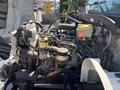 A 2020 Hino 338 truck engine with various mechanical components including fuel filters and fluid reservoirs visible in the foreground