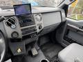 The interior dashboard of a 2011 Ford F-650 displaying controls gauges and a mounted display screen