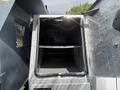 A 2016 RAM 5500 truck with an open storage compartment featuring metal shelves inside and a rugged diamond plate exterior