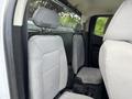 The interior of a 2017 Chevrolet Colorado showing the back seat with gray fabric upholstery and headrests