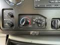 Dashboard controls of a 2013 Ford Econoline featuring knobs for front heat rear heat air conditioning and vent settings