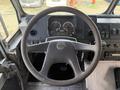 Interior view of a 2017 Freightliner MT45 showing the steering wheel dashboard gauges and control buttons
