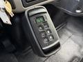 A gear shifter panel featuring buttons for neutral reverse drive mode and directional arrows