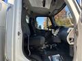 Interior view of a 2005 Freightliner M2 106 truck showcasing the driver's seat dashboard and controls with a focus on the steering wheel and cabin details