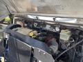 A 2019 Freightliner MT45 engine compartment featuring exposed engine components, hoses, and a coolant reservoir with a large radiator in front